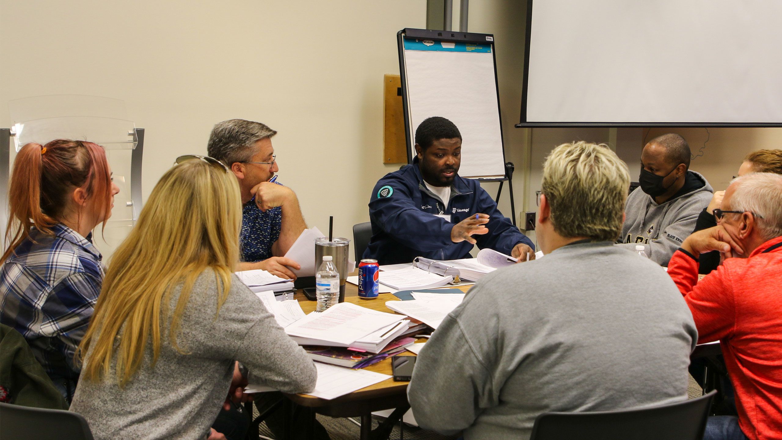 Participants of the HACCP program conversing at a conference table