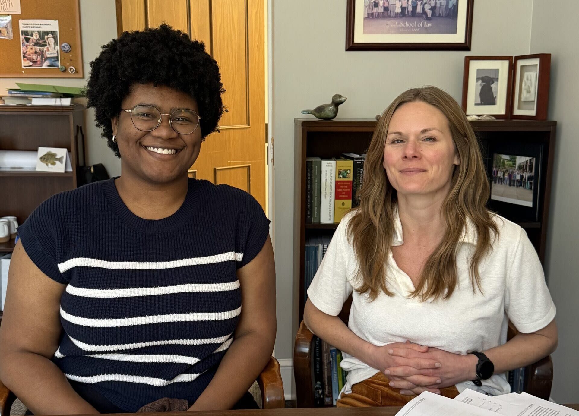 Tamaris Henderson and Katie Hill sitting at a desk next to one another