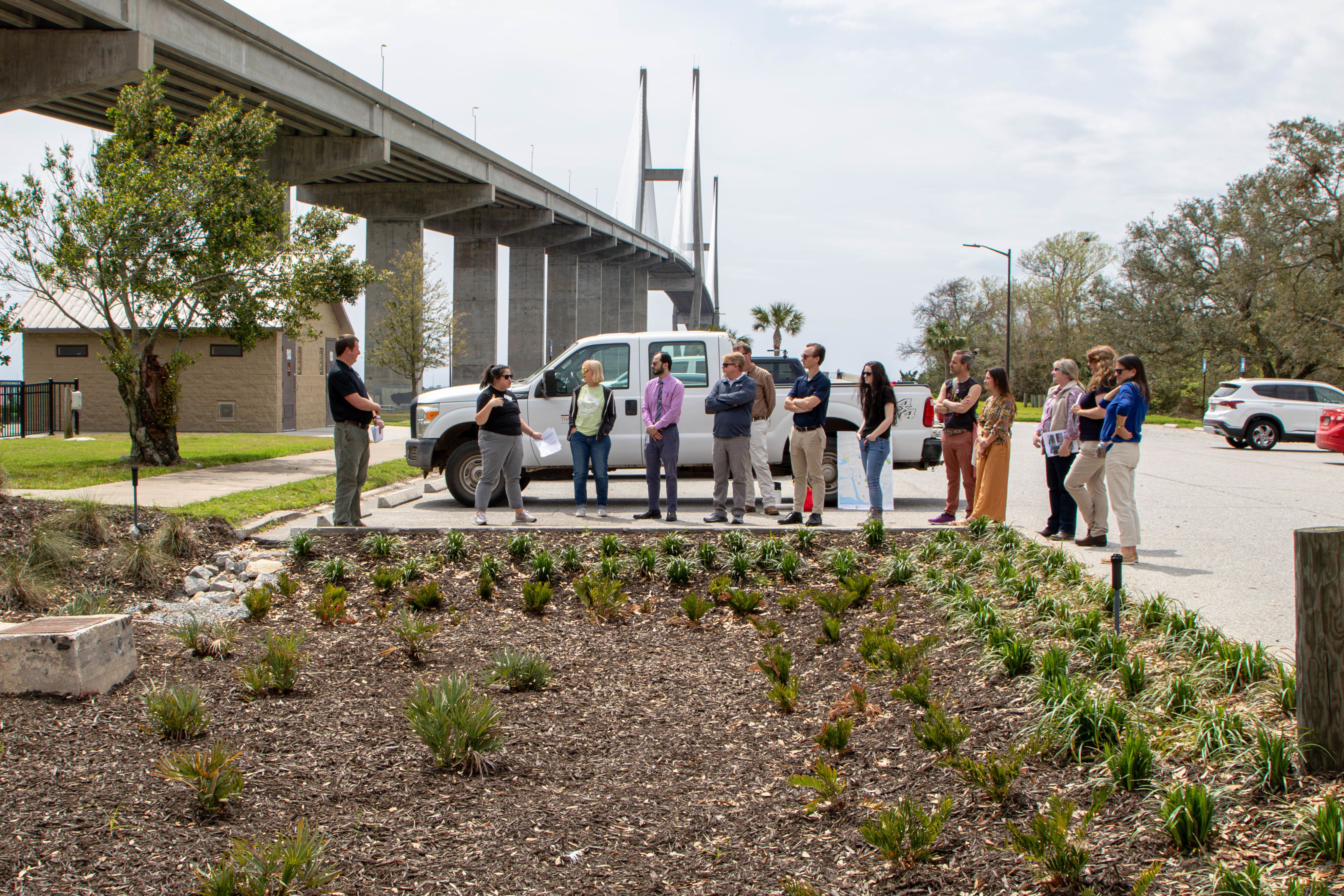 A group of people stand around a bioretention cell installation in Brunswick, GA.